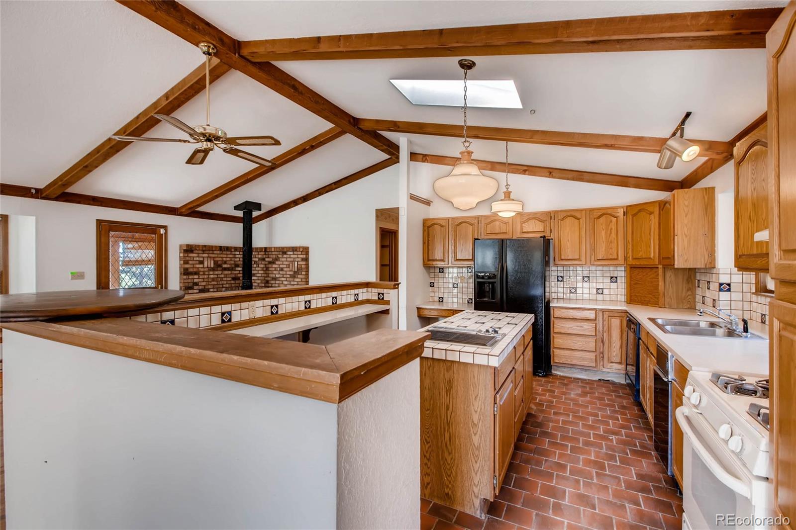 18755 Ranch Hand Road Peyton, CO 80831 - Photo 9 of 27 a kitchen that has a sink stainless steel appliances