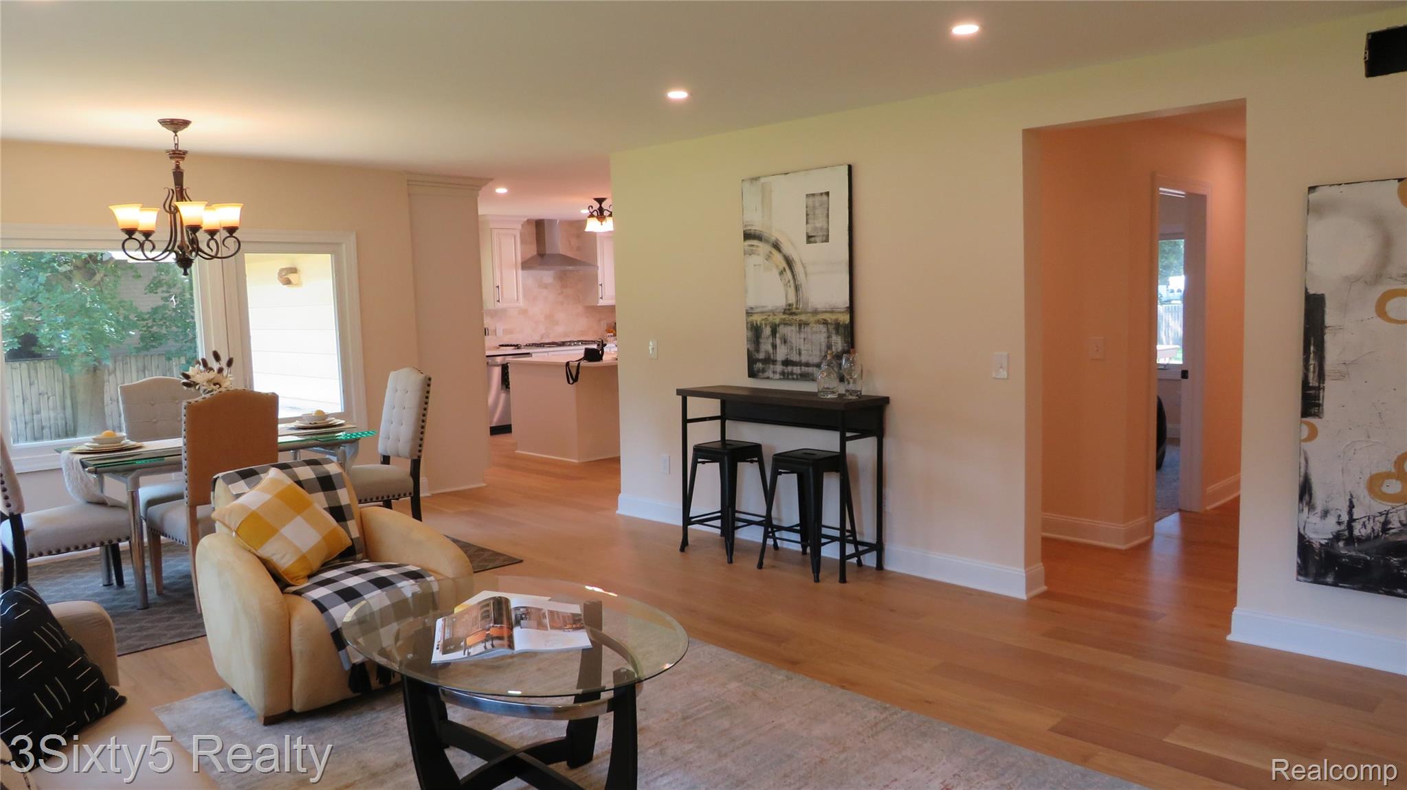 16558 Haggerty Road Belleville, MI 48111 - Photo 5 of 40 Open-concept living space featuring wood-finish flooring, recessed lighting, and a dining area with a chandelier