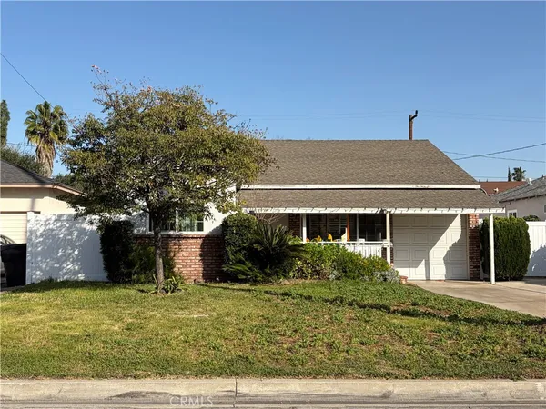 a front view of house with trees