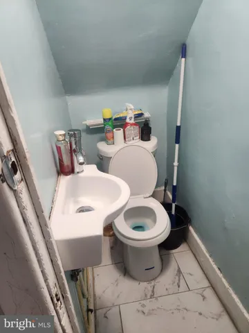 a white toilet sitting next to a bathroom sink