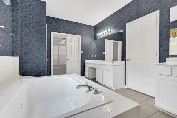a bathroom with a sink a vanity and mirror