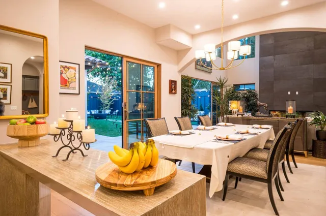 a bedroom with a bed and a potted plant next to a window