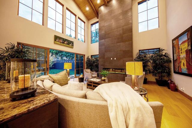 a living room with furniture and a floor to ceiling window