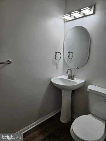 a bathroom with a sink toilet and mirror