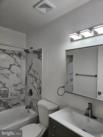 a bathroom with a bathtub and shower