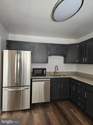 a kitchen with a sink stainless steel appliances and cabinets