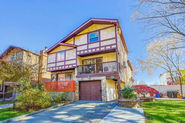 a view of brick house with a yard
