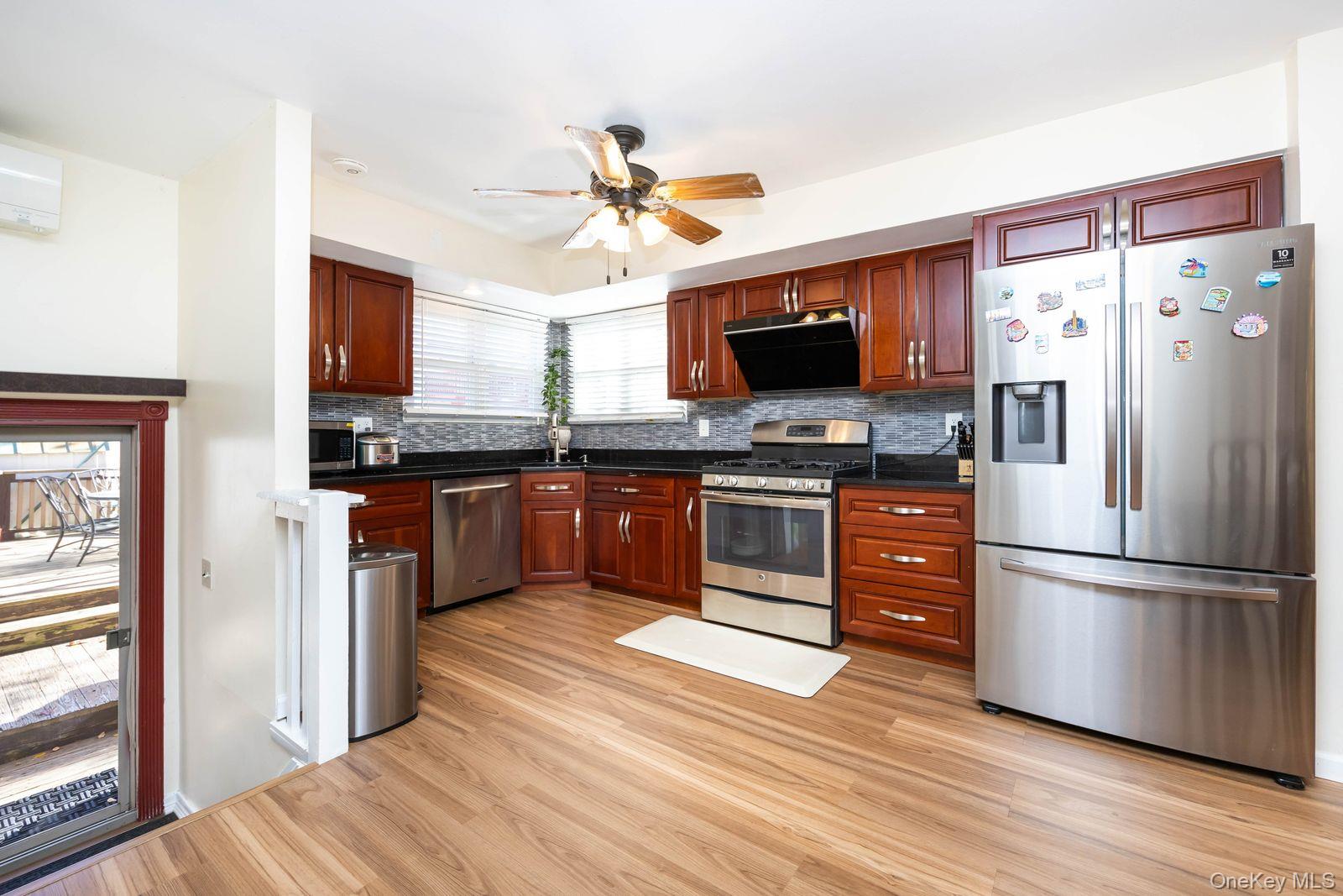 197 Park Drive North Staten Island, NY 10314 - Photo 13 of 37 a kitchen with stainless steel appliances granite countertop a refrigerator a stove top oven a sink and dishwasher