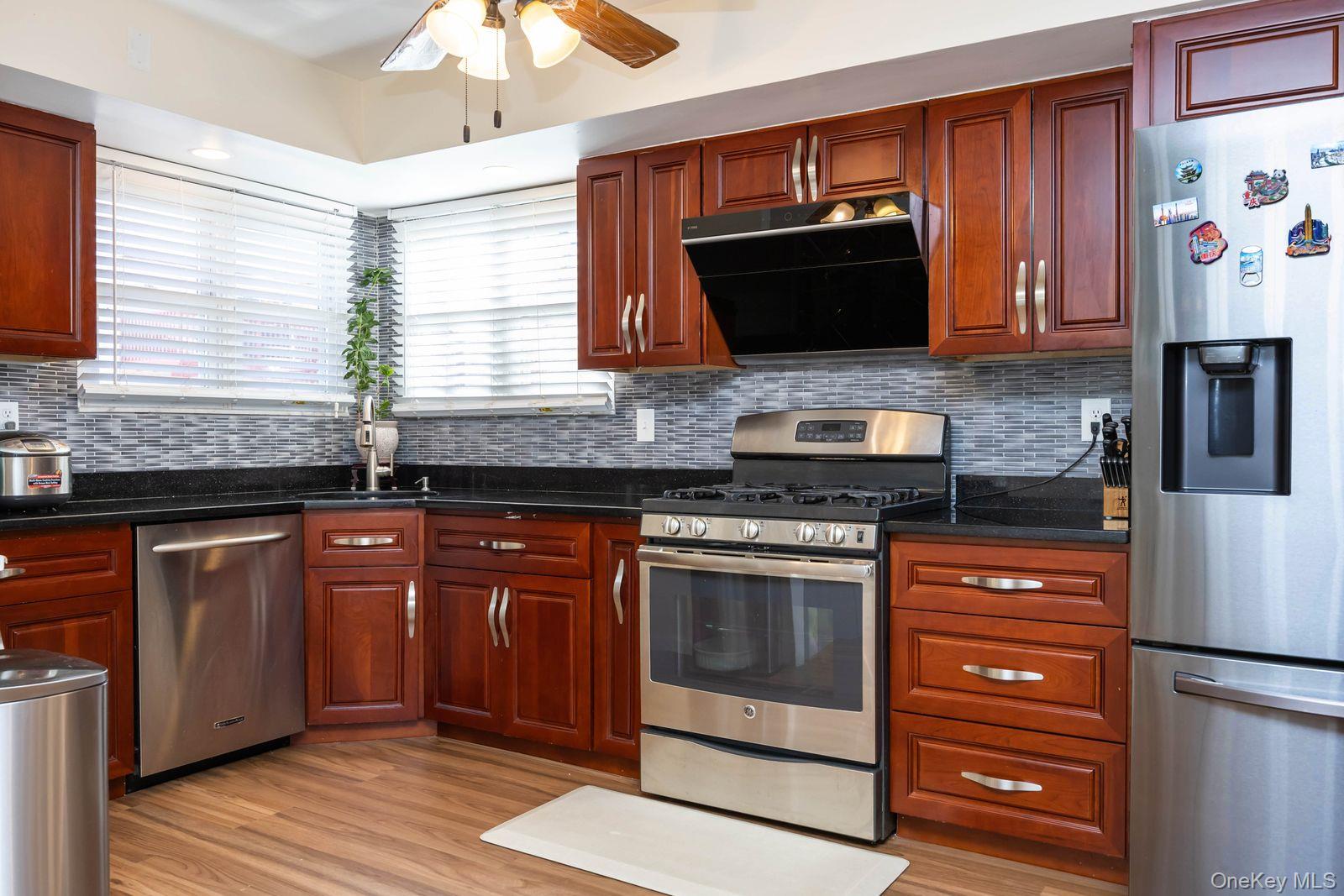 197 Park Drive North Staten Island, NY 10314 - Photo 14 of 37 a kitchen with stainless steel appliances granite countertop a stove microwave and refrigerator