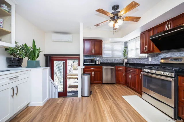 a kitchen with stainless steel appliances granite countertop a stove a sink and a microwave