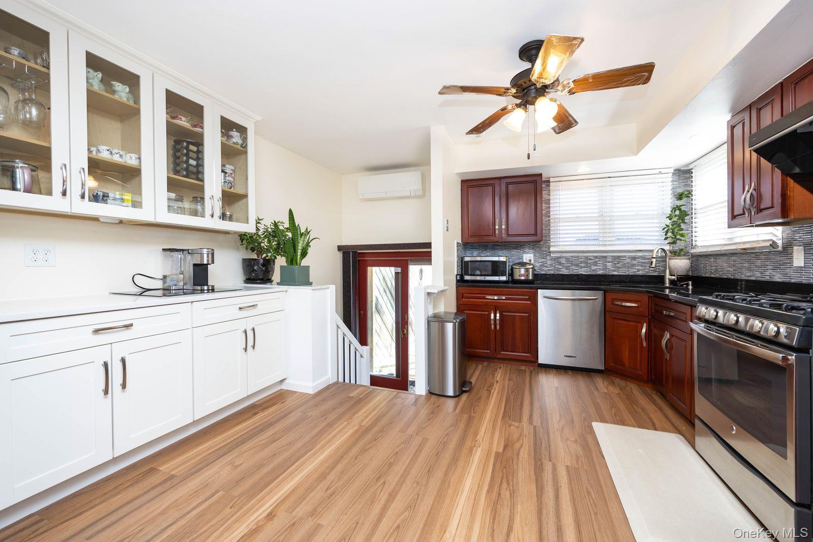 197 Park Drive North Staten Island, NY 10314 - Photo 16 of 37 a kitchen with stainless steel appliances granite countertop a stove cabinets and wooden floor