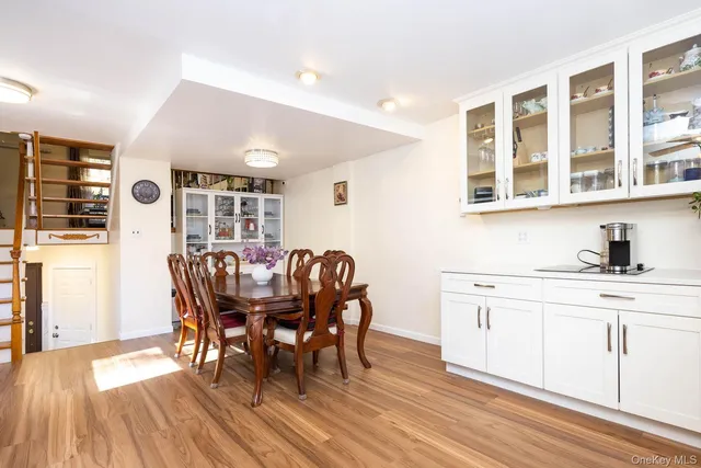 a dining room with furniture and wooden floor