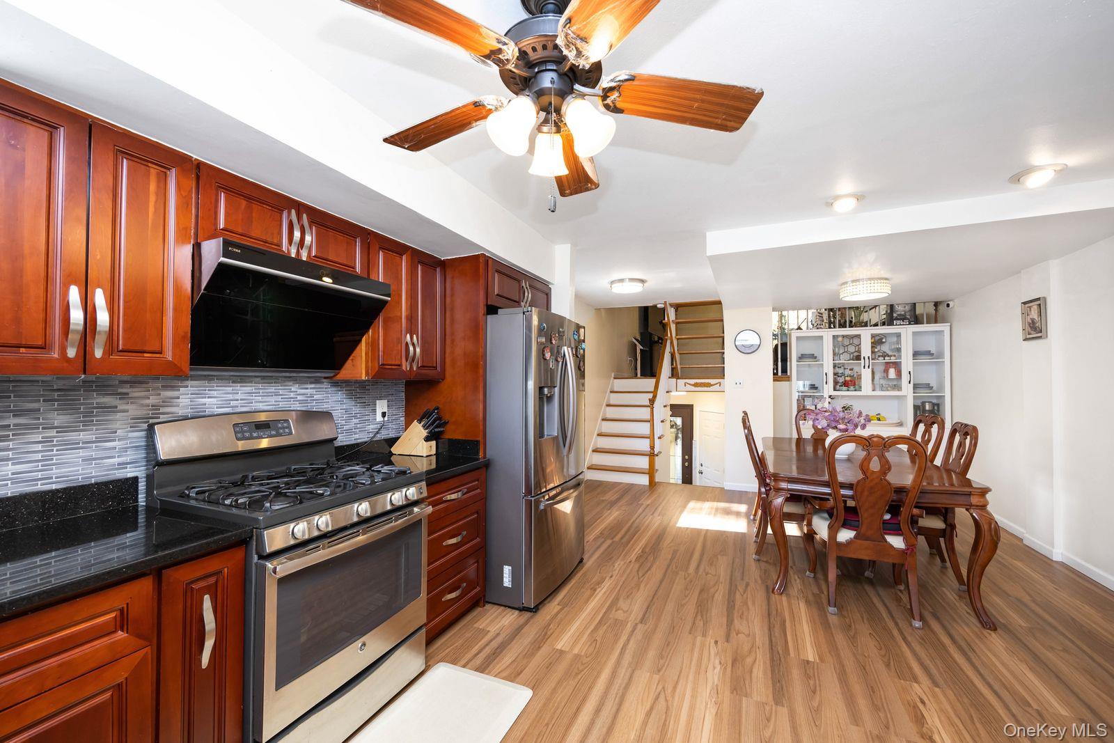 197 Park Drive North Staten Island, NY 10314 - Photo 18 of 37 a kitchen with stainless steel appliances a stove a refrigerator and a dining table