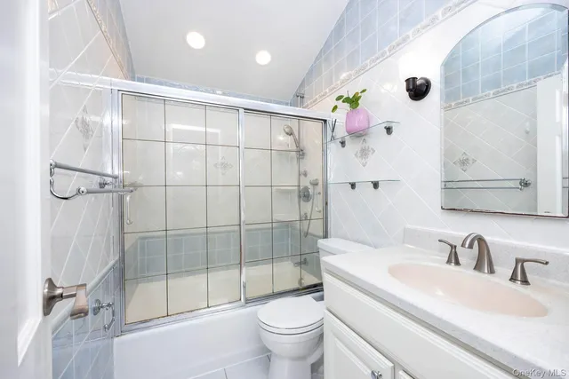 a bathroom with a sink toilet tub and shower