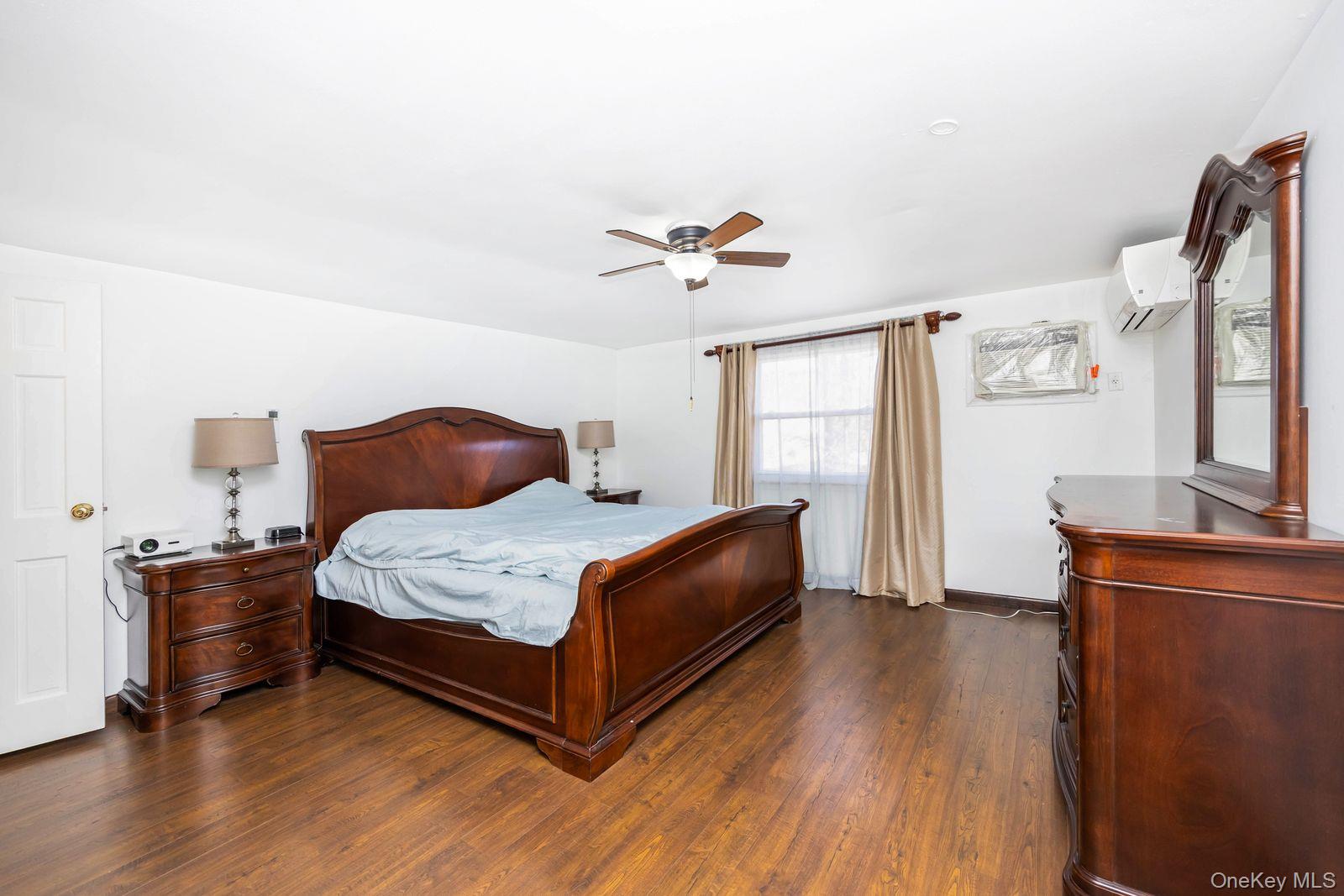 197 Park Drive North Staten Island, NY 10314 - Photo 26 of 37 a bedroom with a bed and wooden floor