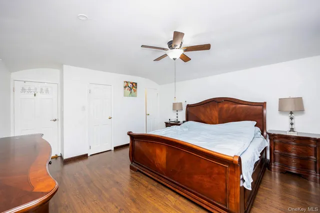 a room with a bed and a dresser