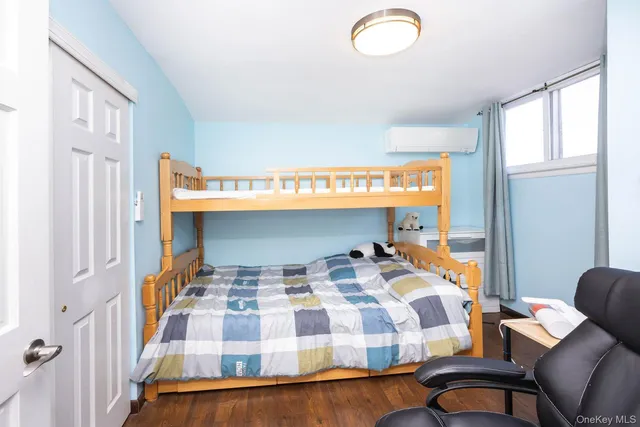 a bedroom with a bed and window