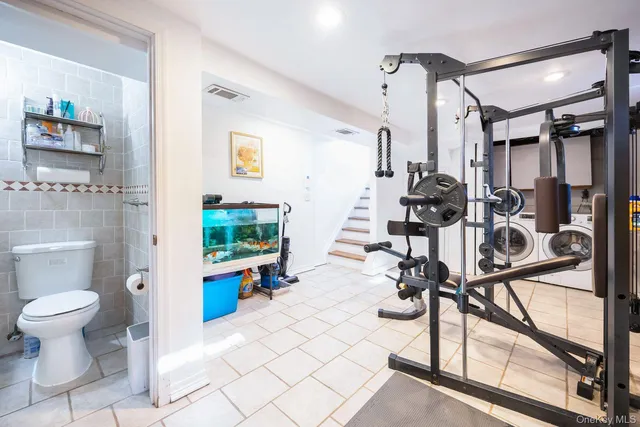 a view of a hallway with wooden floor and furniture