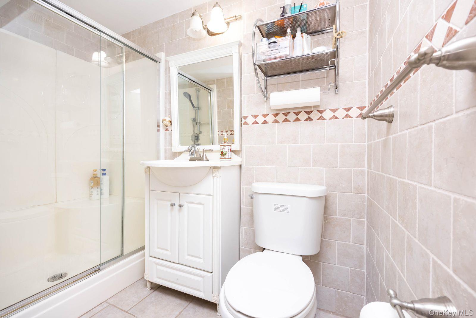 197 Park Drive North Staten Island, NY 10314 - Photo 33 of 37 a bathroom with a sink a toilet and shower