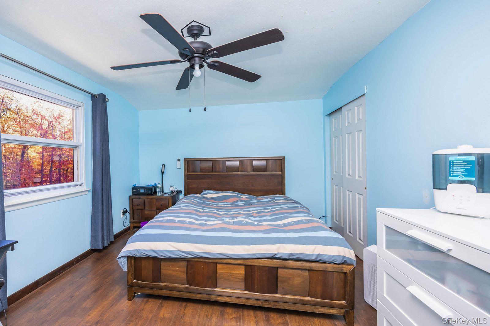 197 Park Drive North Staten Island, NY 10314 - Photo 35 of 37 a bedroom with a bed and wooden floor