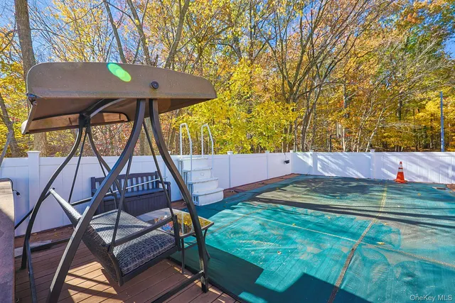 a view of a chairs and table in the backyard