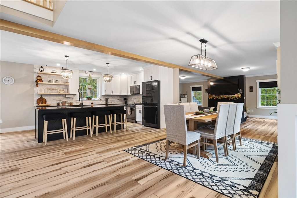1015 Willis Road Phillipston, MA 01331 - Photo 13 of 42 a living room with furniture a dining table and chairs with wooden floor