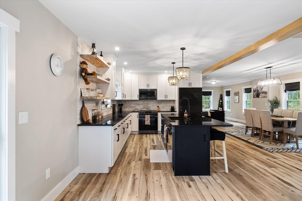 1015 Willis Road Phillipston, MA 01331 - Photo 15 of 42 a living room with lots of furniture and wooden floor