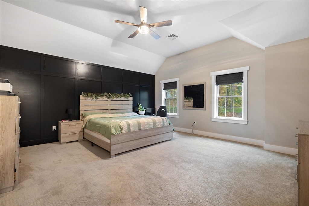 1015 Willis Road Phillipston, MA 01331 - Photo 23 of 42 a bedroom with a large bed and a ceiling fan