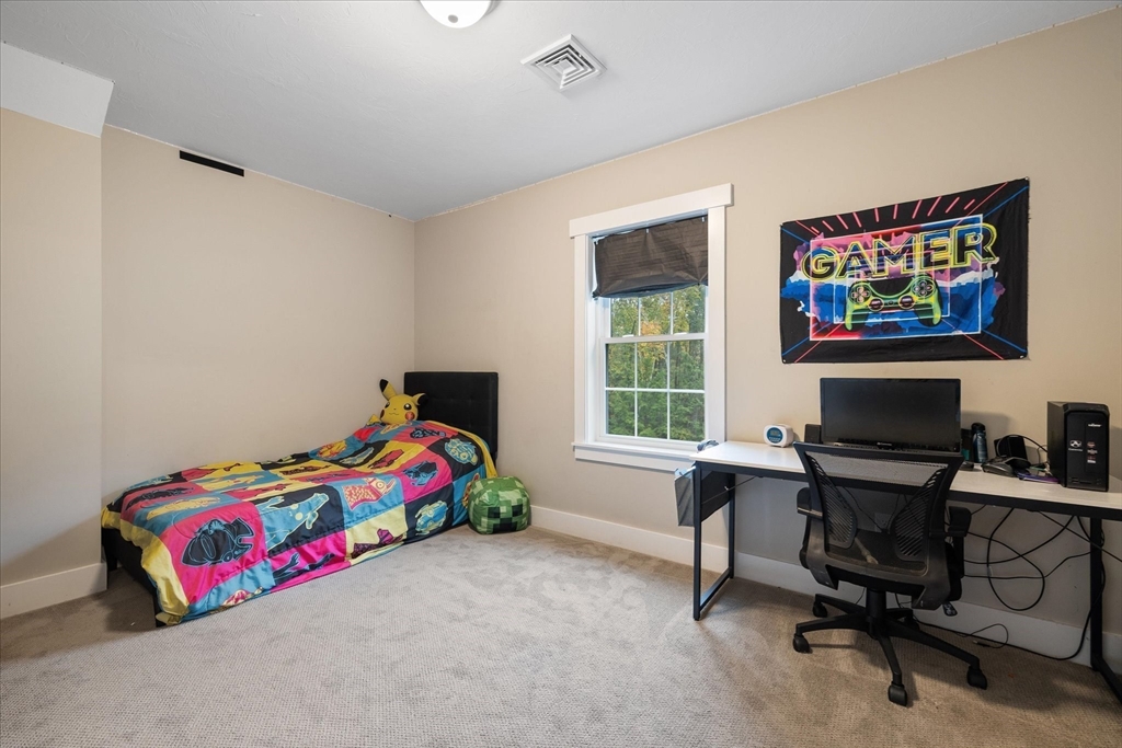 1015 Willis Road Phillipston, MA 01331 - Photo 31 of 42 a bedroom with a bed table chair and a window