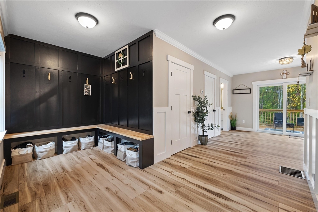 1015 Willis Road Phillipston, MA 01331 - Photo 8 of 42 a view of a hallway with a large mirror and a wooden floor