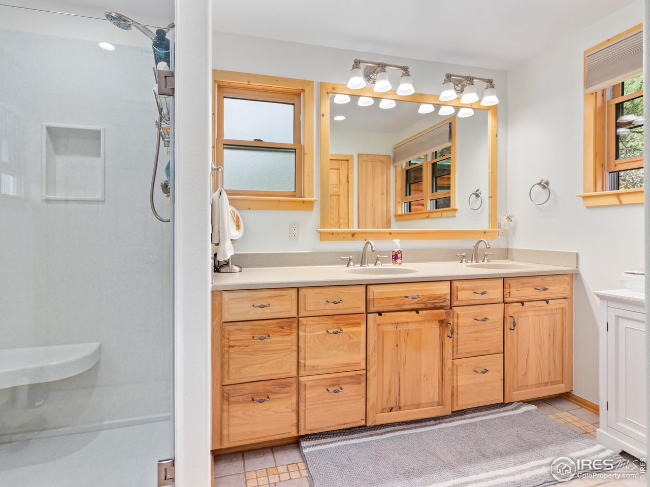 243 Waltonia Road Drake, CO 80515 - Photo 15 of 38 a bathroom with a granite countertop double vanity sink mirror and