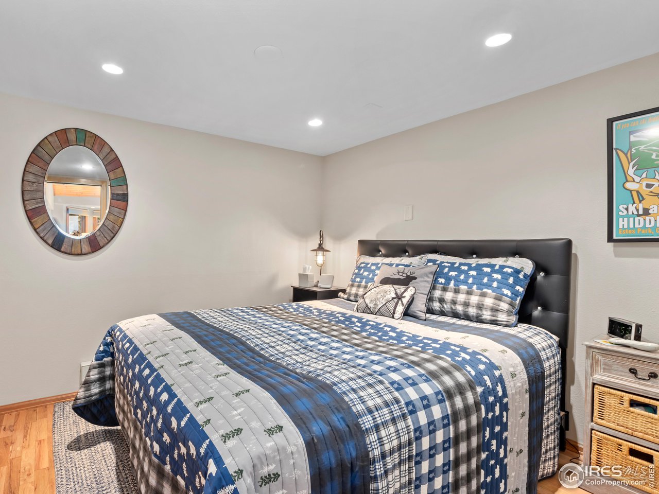 243 Waltonia Road Drake, CO 80515 - Photo 19 of 38 a bedroom with a large bed and a painting on the wall