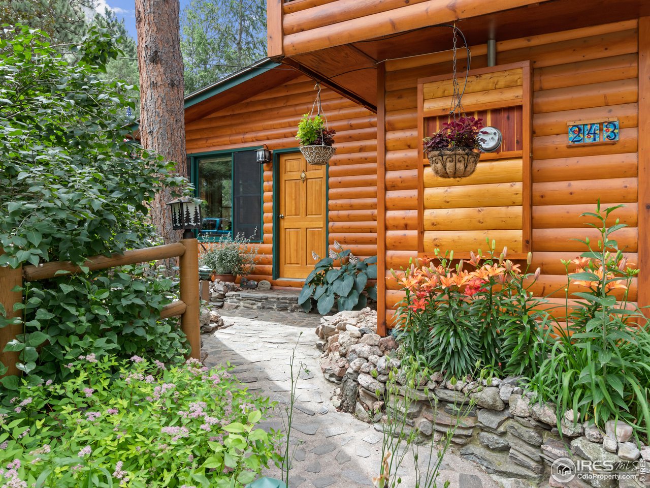 243 Waltonia Road Drake, CO 80515 - Photo 2 of 38 a view of a house with a small yard and potted plants