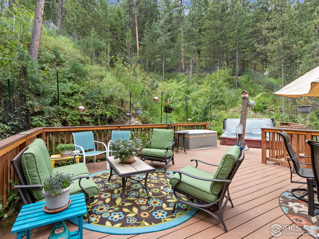 243 Waltonia Road Drake, CO 80515 - Photo 28 of 38 a balcony with wooden floor table and chairs