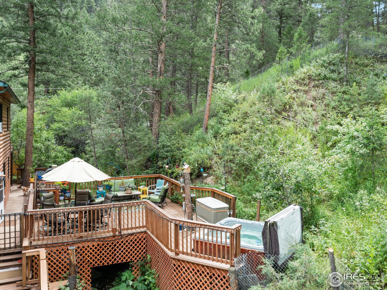 243 Waltonia Road Drake, CO 80515 - Photo 32 of 38 a view of a roof deck with chair and wooden fence