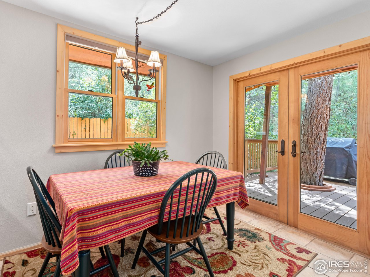 243 Waltonia Road Drake, CO 80515 - Photo 10 of 38 a view of a dining room with furniture window and wooden floor