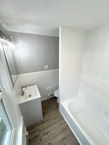a bathroom with a bathtub and toilet