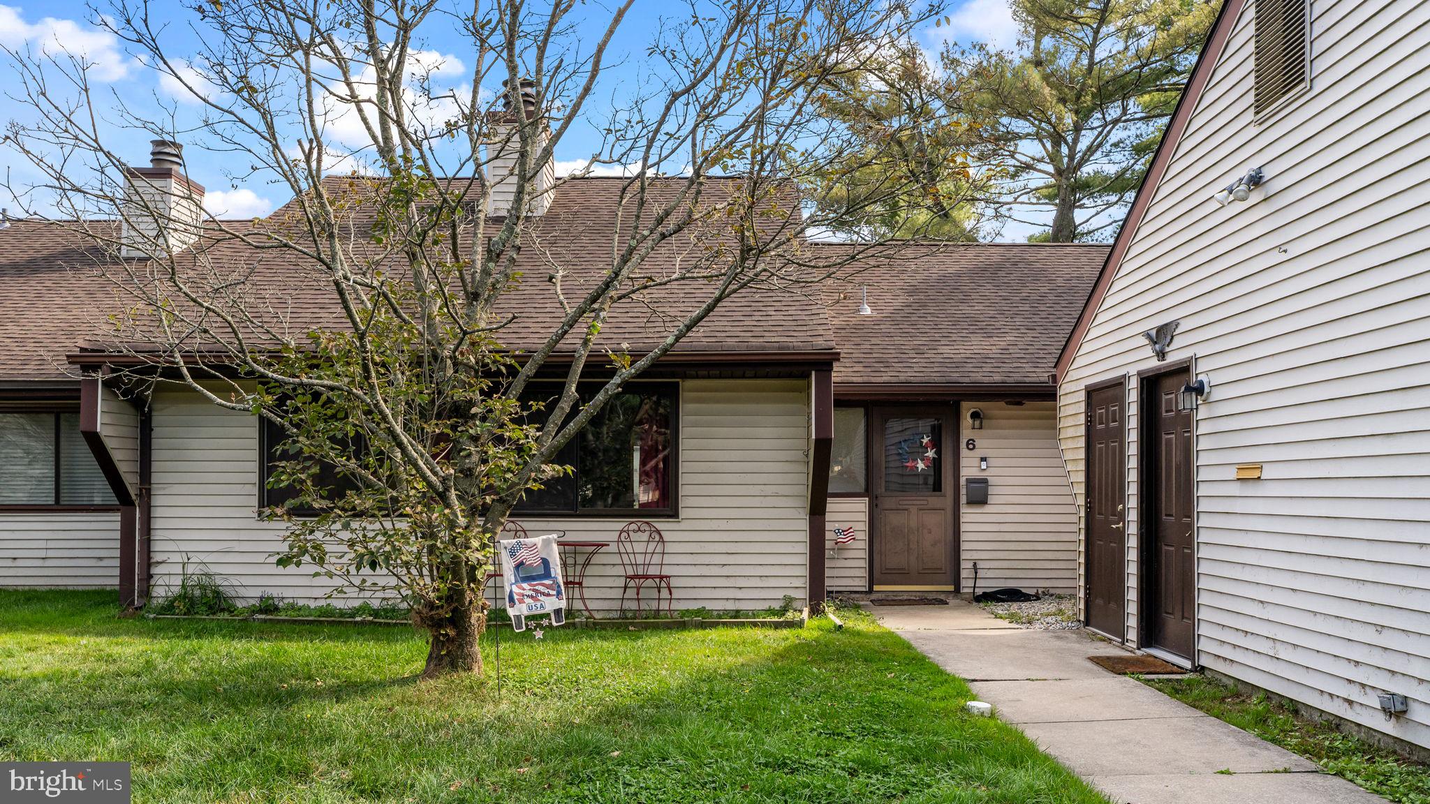 a view of a backyard with a tree