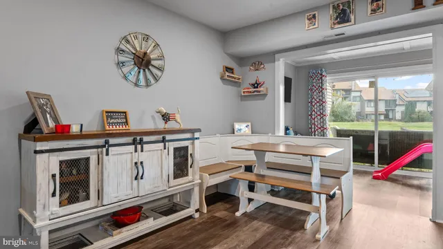a view of a dining room with furniture wooden floor and a chandelier