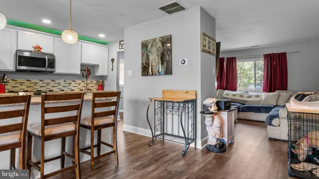 a view of a a dining room with furniture window and wooden floor