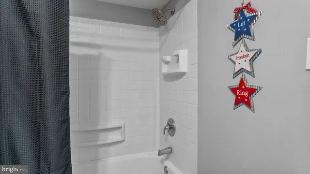 a bathroom with a shower curtain and a sink