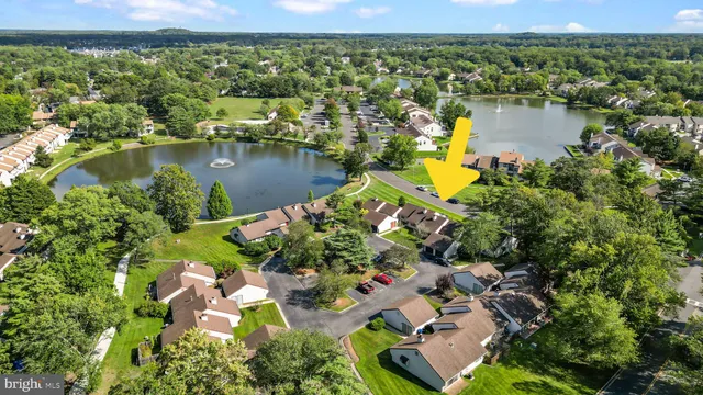 an aerial view of residential houses with outdoor space and lake view