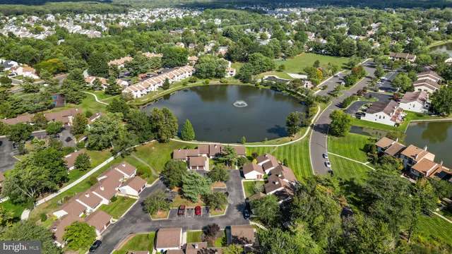 an aerial view of lake residential houses with outdoor space and swimming pool
