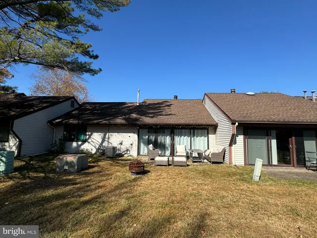 a view of a patio with table and chairs and potted plants