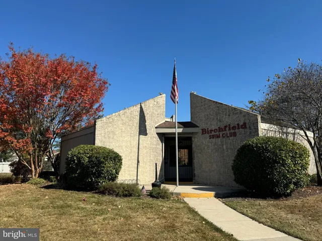 a view of a swimming pool with a yard