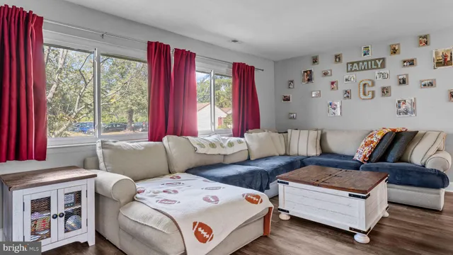 a living room with furniture and large windows