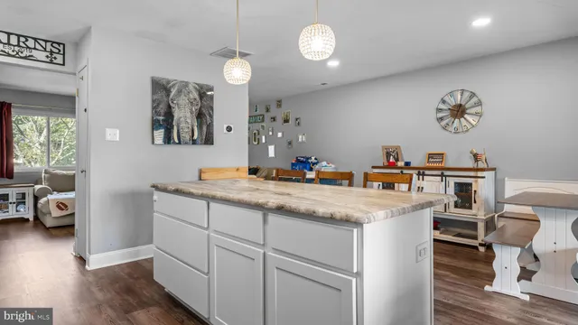 a kitchen with cabinets and wooden floor