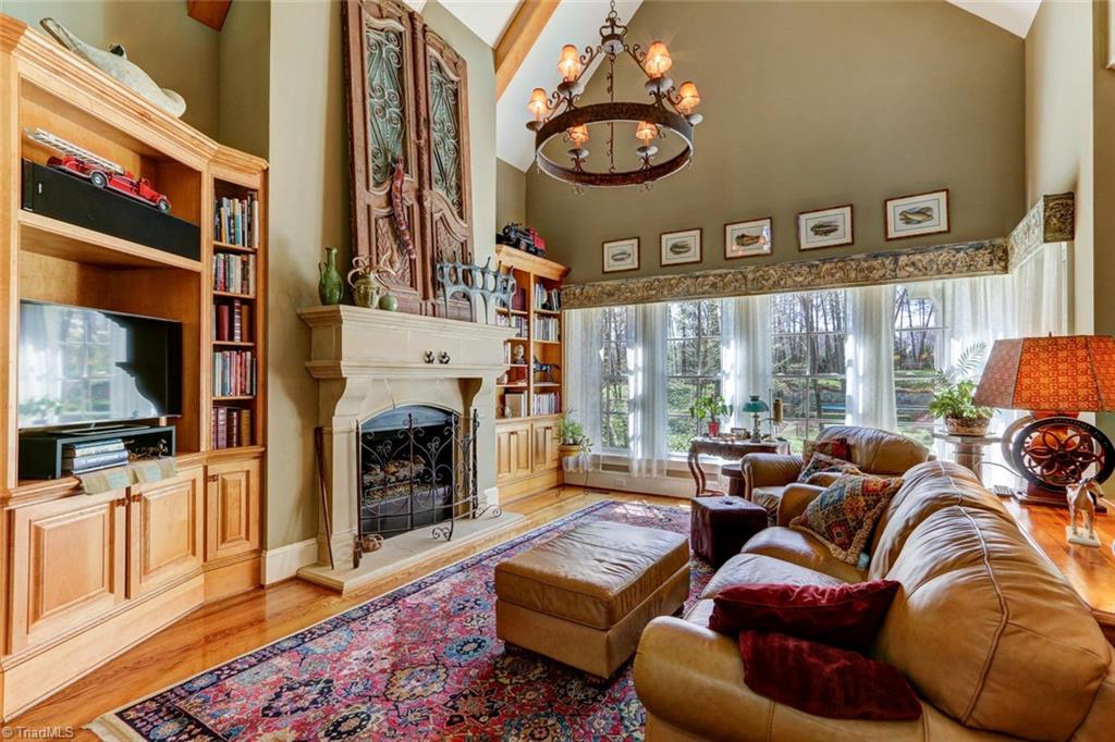 5809 Henson Farm Road Summerfield, NC 27358 - Photo 5 of 29 The great room is spacious, sophisticated and timeless. Finely crafted built-ins flank the oversized cast fireplace, beamed vaulted ceiling adds volume to this light and airy space.