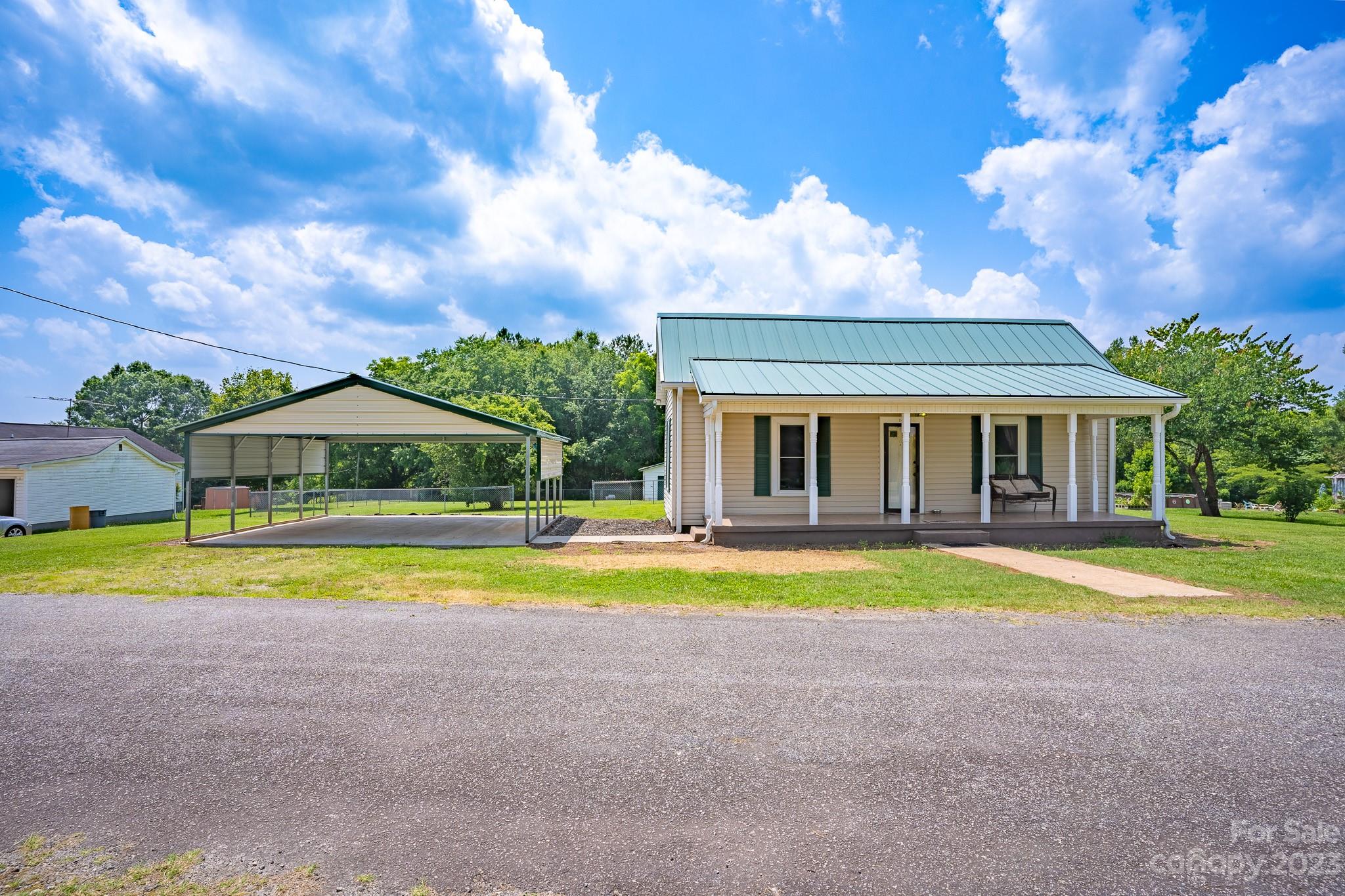 a front view of a house with swimming pool and a yard