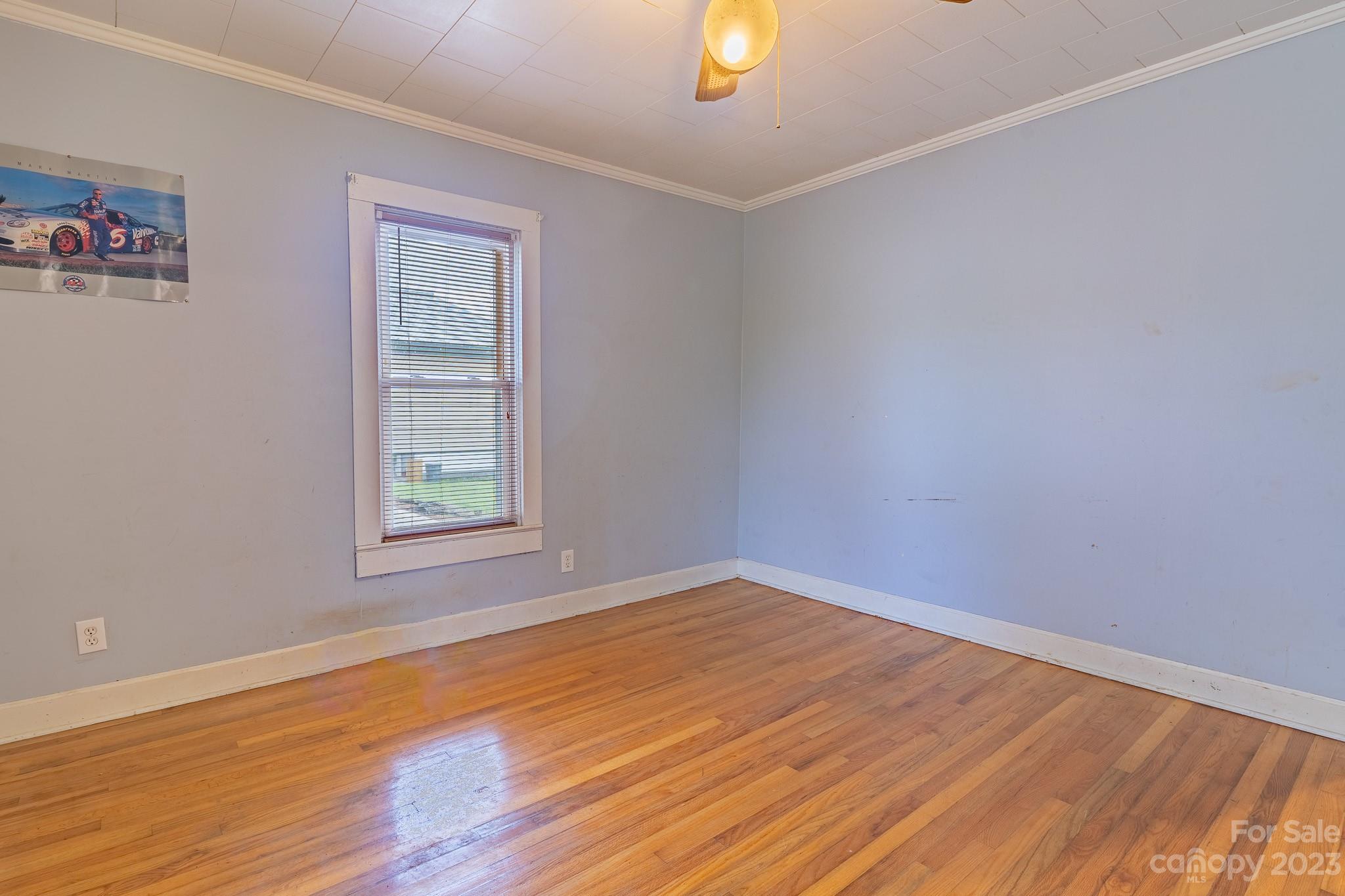 146 Sorrells Road Rutherfordton, NC 28139 - Photo 12 of 25 an empty room with wooden floor and windows